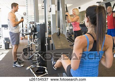 Stock Photo - Group Of People Weight Training At Gym. Fotosearch