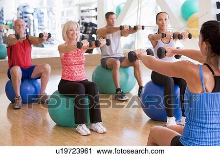 Instructor Taking Exercise Class At Gym View Large Photo Image Stock Image - Instructor Taking Exercise Class At Gym. Fotosearch