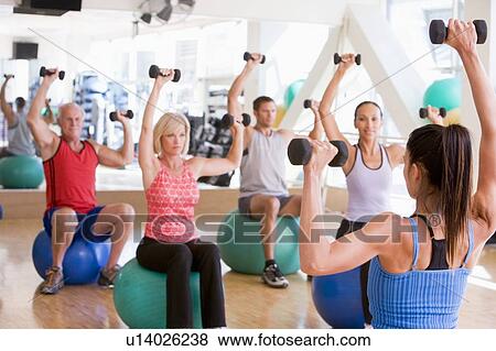 Instructor Taking Exercise Class At Gym View Large Photo Image Stock Photo - Instructor Taking Exercise Class At Gym. Fotosearch