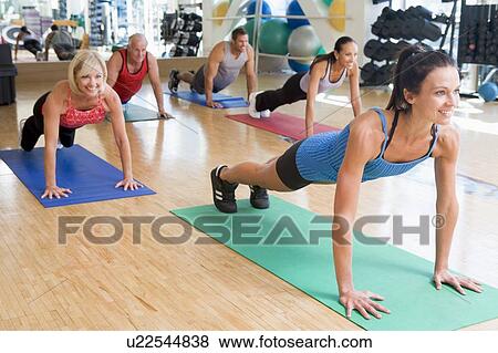 Instructor Taking Exercise Class At Gym View Large Photo Image Stock Photo - Instructor Taking Exercise Class At Gym. Fotosearch