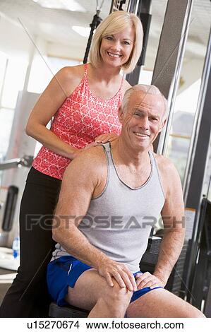 Picture - Man And Woman At Gym Together. Fotosearch