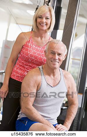 Stock Photograph - Man And Woman At Gym Together. Fotosearch
