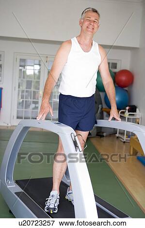 Man Running On Treadmill At Gym View Large Photo Image Stock Photo - Man Running On Treadmill At Gym. Fotosearch