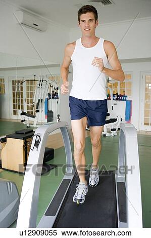 Man Running On Treadmill At Gym View Large Photo Image Stock Photography - Man Running On Treadmill At Gym. Fotosearch