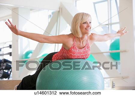 Stock Image - Woman Balancing On Swiss Ball. Fotosearch