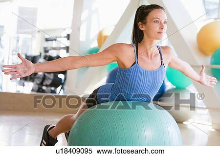 Stock Photography - Woman Balancing On Swiss Ball. Fotosearch