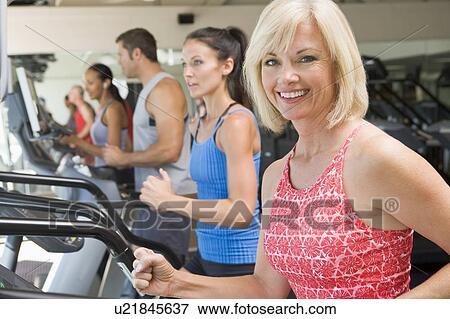 Woman Running On Treadmill At Gym View Large Photo Image Stock Photo - Woman Running On Treadmill At Gym. Fotosearch