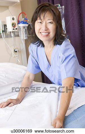 A Nurse Making A Bed In A Hospital Ward View Large Photo Image Stock Photo - A Nurse Making A Bed In A Hospital Ward. Fotosearch