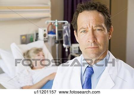 Stock Photo - Doctor Standing In Patients Room. Fotosearch