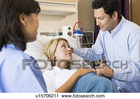 Doctor Talking To Pregnant Woman And Her Husband View Large Photo Image Stock Image - Doctor Talking To Pregnant Woman And Her Husband. Fotosearch