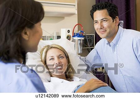 Doctor Talking To Pregnant Woman And Her Husband View Large Photo Image Stock Photo - Doctor Talking To Pregnant Woman And Her Husband. Fotosearch