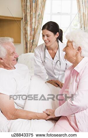 Doctor Talking To Senior Man And His Wife View Large Photo Image Stock Photography - Doctor Talking To Senior Man And His Wife. Fotosearch