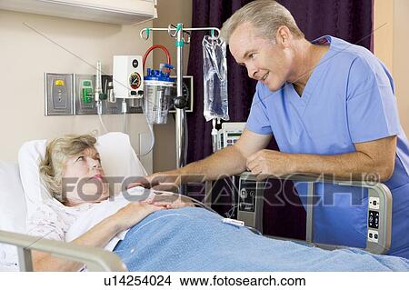 Doctor Talking To Senior Woman View Large Photo Image Picture - Doctor Talking To Senior Woman. Fotosearch