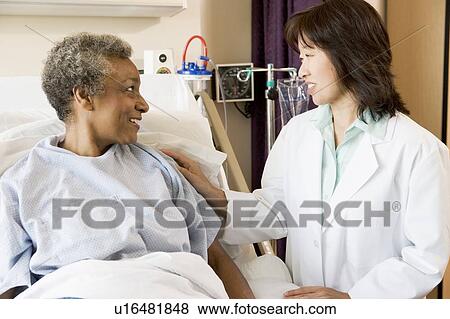 Doctor Talking To Senior Woman View Large Photo Image Stock Photo - Doctor Talking To Senior Woman. Fotosearch
