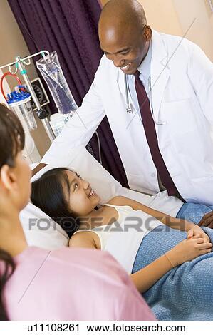 Doctor Talking To Young Girl View Large Photo Image Stock Image - Doctor Talking To Young Girl. Fotosearch