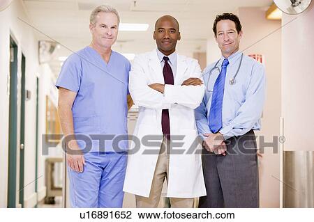 Stock Image - Doctors Standing In A Hospital Corridor. Fotosearch