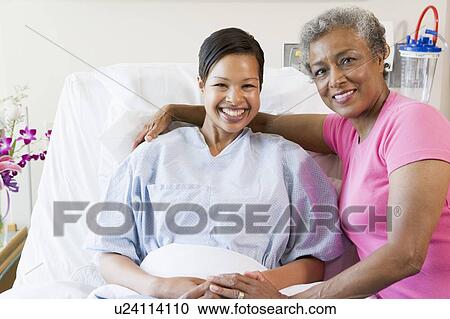 Stock Image - Mother And Daughter Smiling In Hospital. Fotosearch