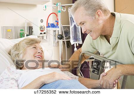 Stock Image - Mother And Son Laughing Together In Hospital. Fotosearch