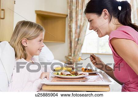 Picture - Nurse Feeding Young Girl. Fotosearch