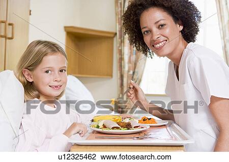 Nurse Feeding Young Girl View Large Photo Image Stock Image - Nurse Feeding Young Girl. Fotosearch