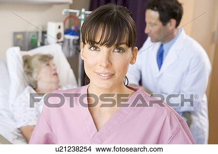 Picture - Nurse Standing In Hospital Room, Doctor Talking With Patient. Fotosearch