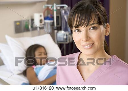 Stock Image - Nurse Standing In Hospital Room. Fotosearch