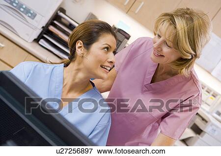 Stock Photo - Nurses At The Reception Area Of A Hospital. Fotosearch