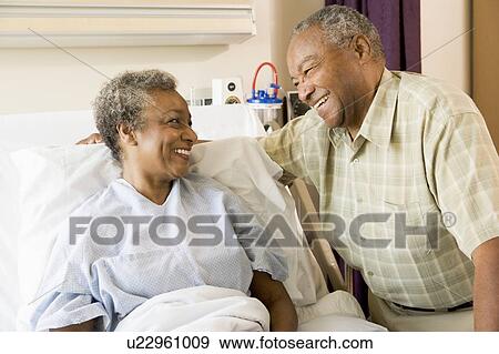 Stock Photo - Senior Couple Smiling At Each Other In Hospital. Fotosearch