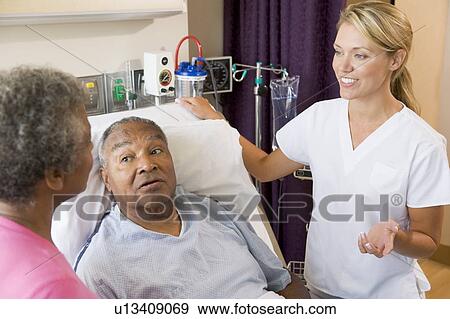 Stock Photo - Senior Couple Talking To Doctor. Fotosearch
