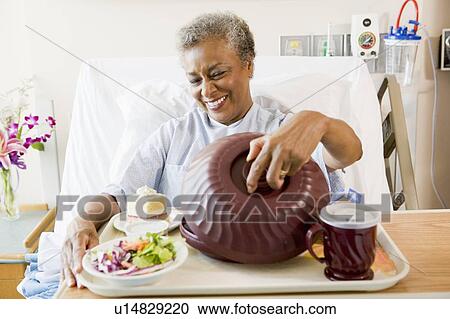 Senior Woman Sitting In Hospital Bed With A Tray Of Food View Large Photo Image Stock Image - Senior Woman Sitting In Hospital Bed With A Tray Of Food. Fotosearch