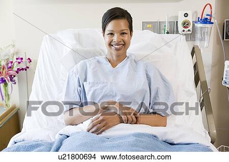 Picture - Woman Sitting In Hospital Bed. Fotosearch