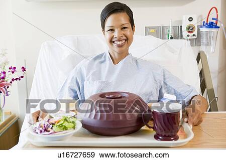 Woman Sitting In Hospital Bed With A Tray Of Food View Large Photo Image Stock Photo - Woman Sitting In Hospital Bed With A Tray Of Food. Fotosearch