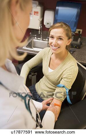 Stock Image - Young Woman Having Blood Test Done. Fotosearch