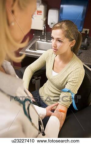 Stock Image - Young Woman Having Blood Test Done. Fotosearch