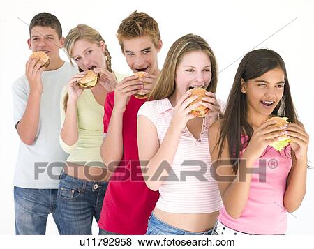 Row of five friends eating hamburgers View Large Photo Image Stock Photo - Row of five friends eating hamburgers. Fotosearch