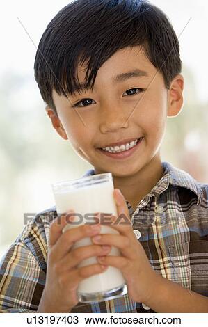Young boy indoors drinking milk smiling View Large Photo Image Stock Image - Young boy indoors drinking milk smiling. Fotosearch