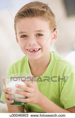 Young boy indoors drinking milk smiling View Large Photo Image Stock Image - Young boy indoors drinking milk smiling. Fotosearch
