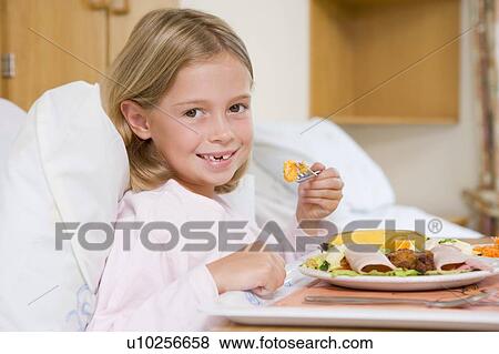 Stock Photo - Young Girl Eating Hospital Food. Fotosearch