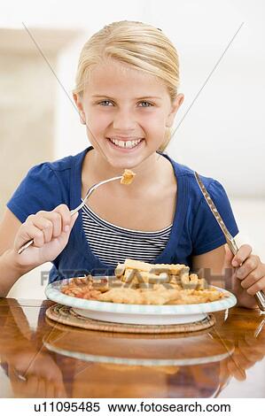 Young girl indoors eating fish and chips smiling View Large Photo Image Stock Photography - Young girl indoors eating fish and chips smiling. Fotosearch