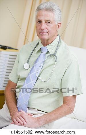 Stock Image - A Doctor Sitting On A Hospital Bed. Fotosearch
