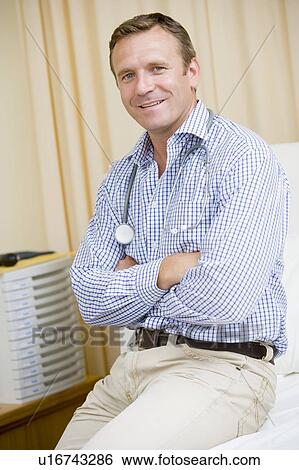 A Doctor Sitting On A Hospital Bed View Large Photo Image Stock Photograph - A Doctor Sitting On A Hospital Bed. Fotosearch