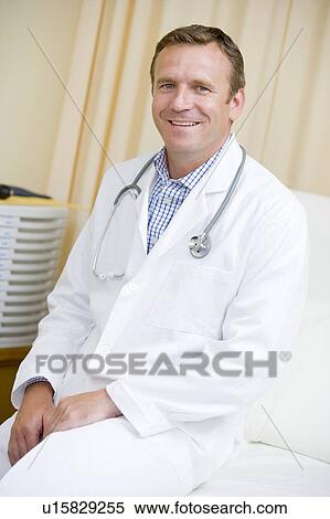 Stock Photography - A Doctor Sitting On A Hospital Bed. Fotosearch