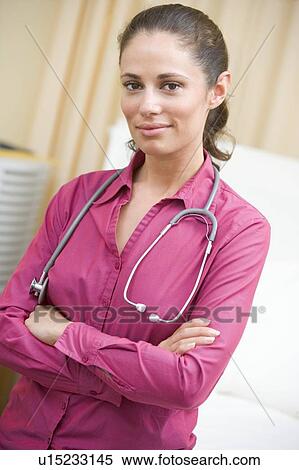 Stock Photography - A Doctor Standing In A Hospital Ward. Fotosearch