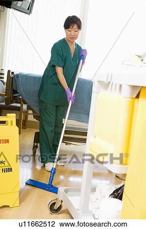 Stock Image - An Orderly Mopping The Floor In A Hospital Ward. Fotosearch