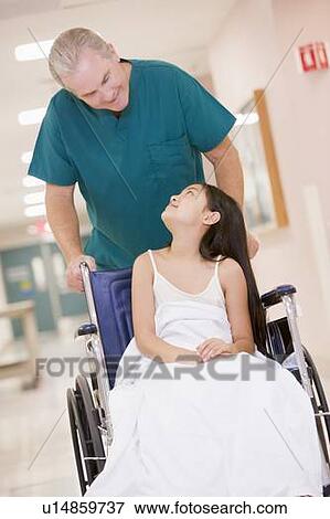 An Orderly Pushing A Little Girl In A Wheelchair Down A Hospital Corridor View Large Photo Image Stock Photo - An Orderly Pushing A Little Girl In A Wheelchair Down A Hospital Corridor. Fotosearch