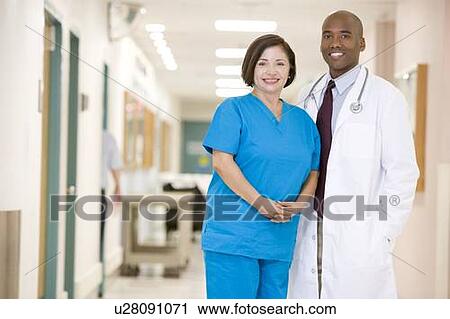Doctor And Nurse Standing In A Hospital Corridor View Large Photo Image Stock Image - Doctor And Nurse Standing In A Hospital Corridor. Fotosearch