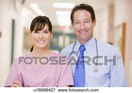 Doctor And Nurse Standing In A Hospital Corridor View Large Photo Image Stock Photo - Doctor And Nurse Standing In A Hospital Corridor. Fotosearch