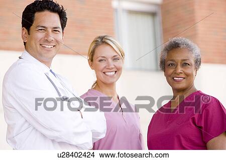 Doctor And Nurses Standing Outside A Hospital View Large Photo Image Picture - Doctor And Nurses Standing Outside A Hospital. Fotosearch