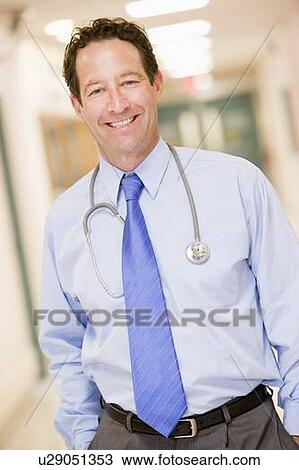 Stock Image - Doctor Standing In A Hospital Corridor. Fotosearch