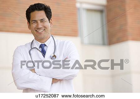 Doctor Standing Outside A Hospital View Large Photo Image Stock Photo - Doctor Standing Outside A Hospital. Fotosearch